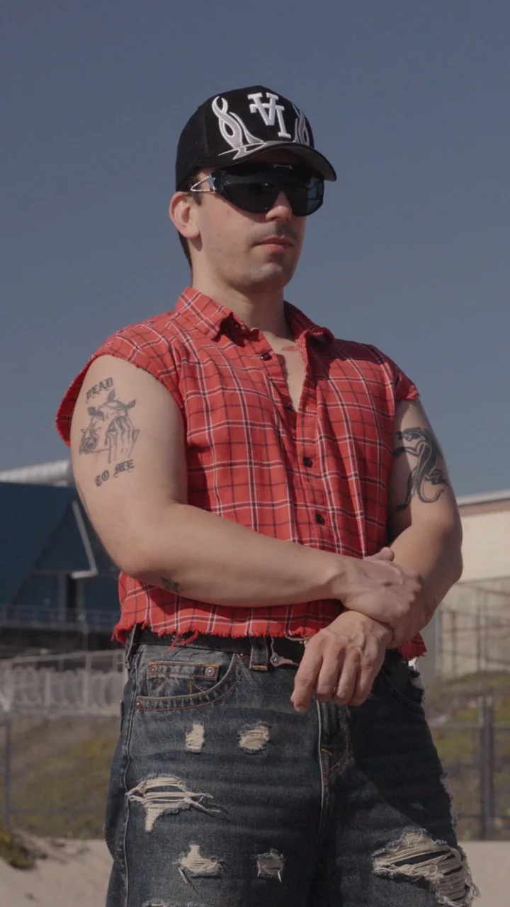 Intrnet Boyfriend artist promo: the artist in a red flannel and sunglasses
